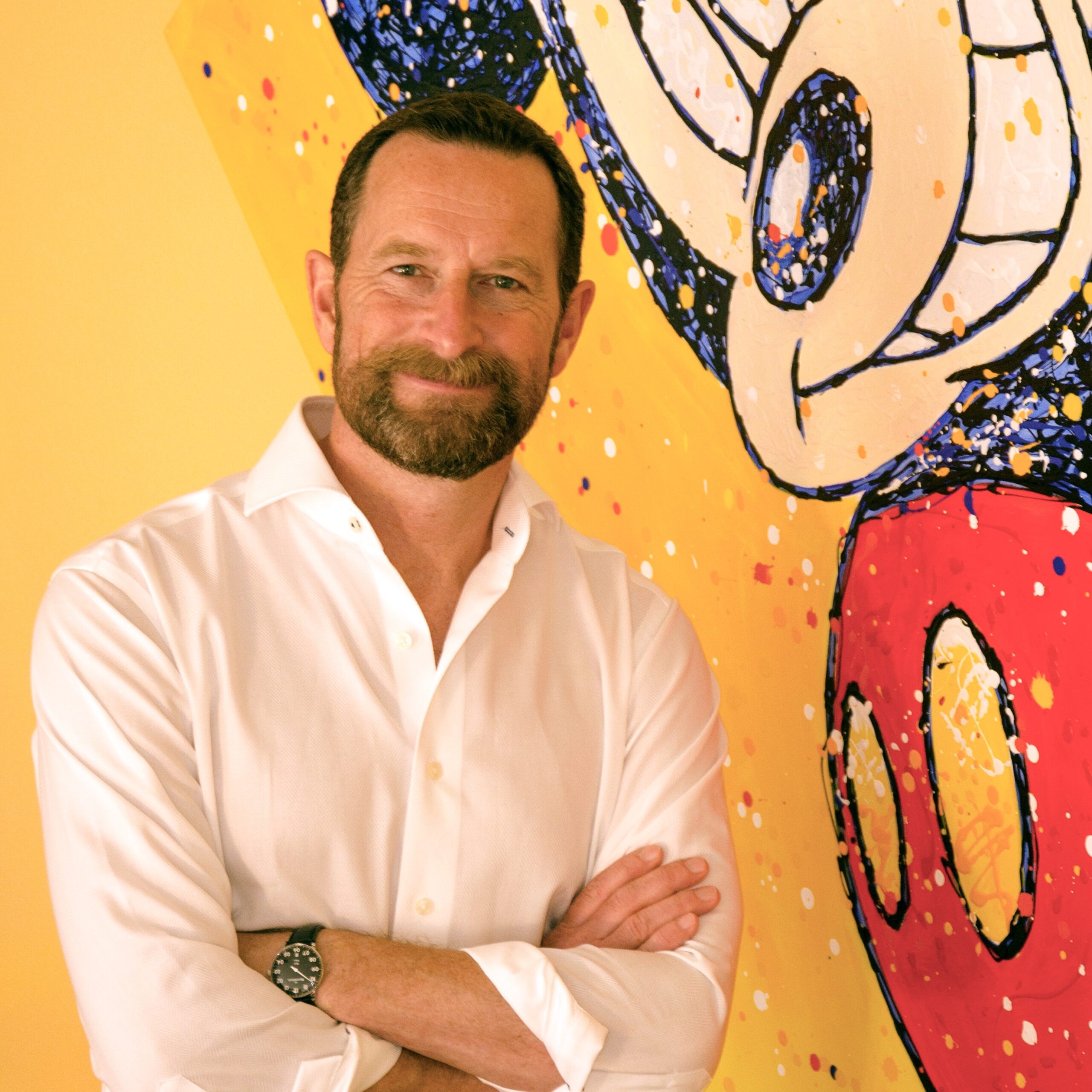 Duncan-Wardle-Smiling-in-front-of-Mickey-Mouse-Painting-scaled